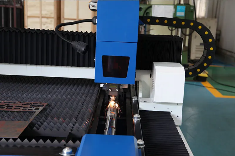 Close-up of laser cutting head and pipe processing unit