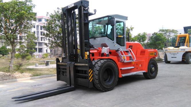 Red heavy duty forklift in operation