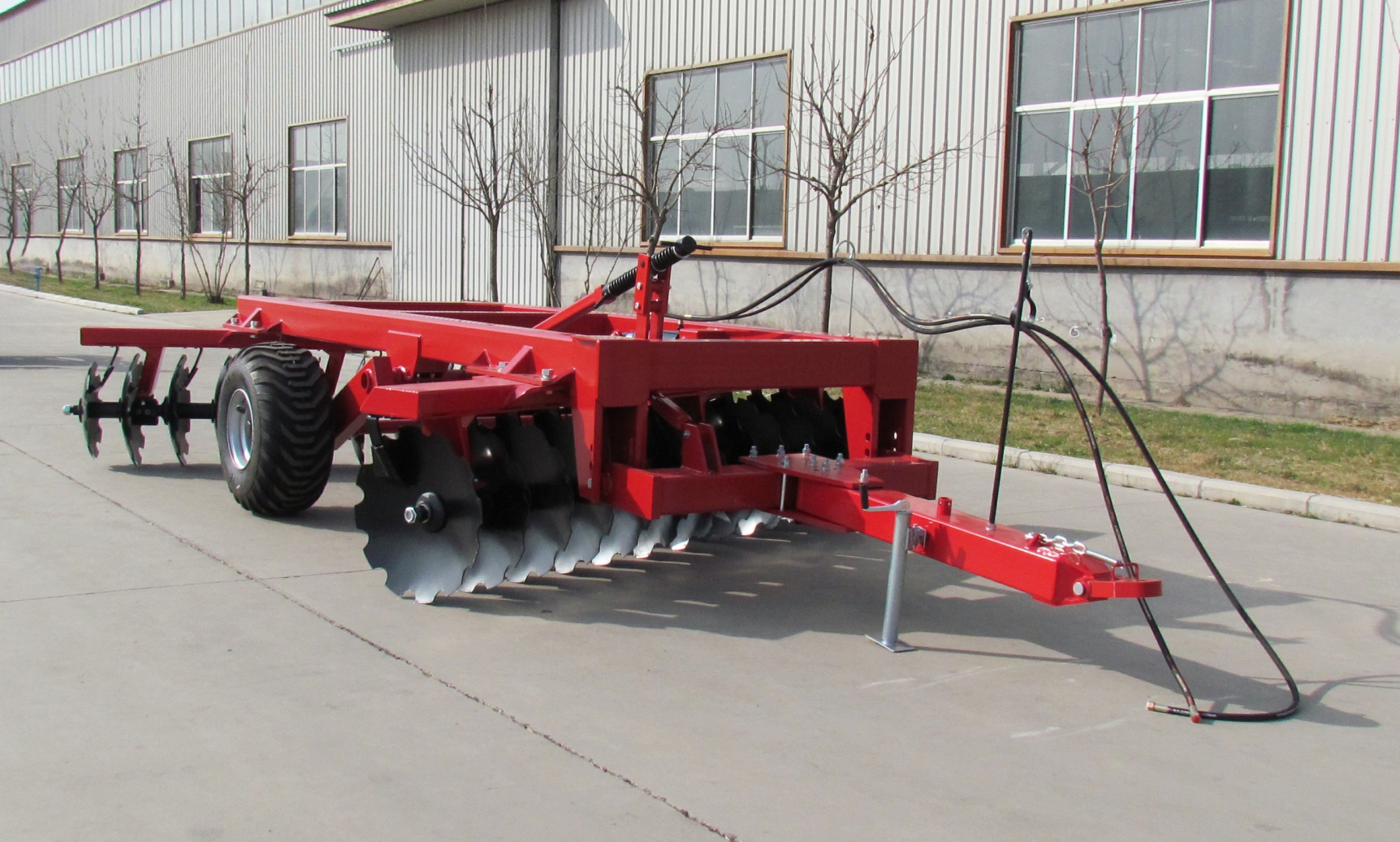 Close up of heavy duty notched discs and hydraulic cylinders