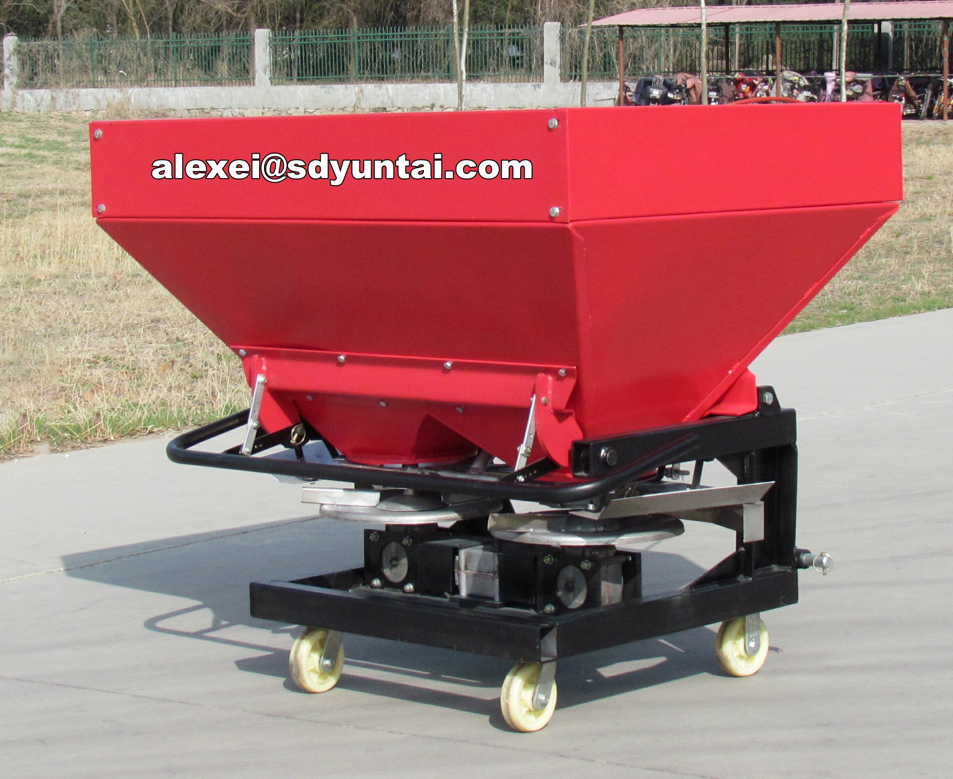 2CDRX-800 Double Disc Spreader with large red hopper and wheeled chassis
