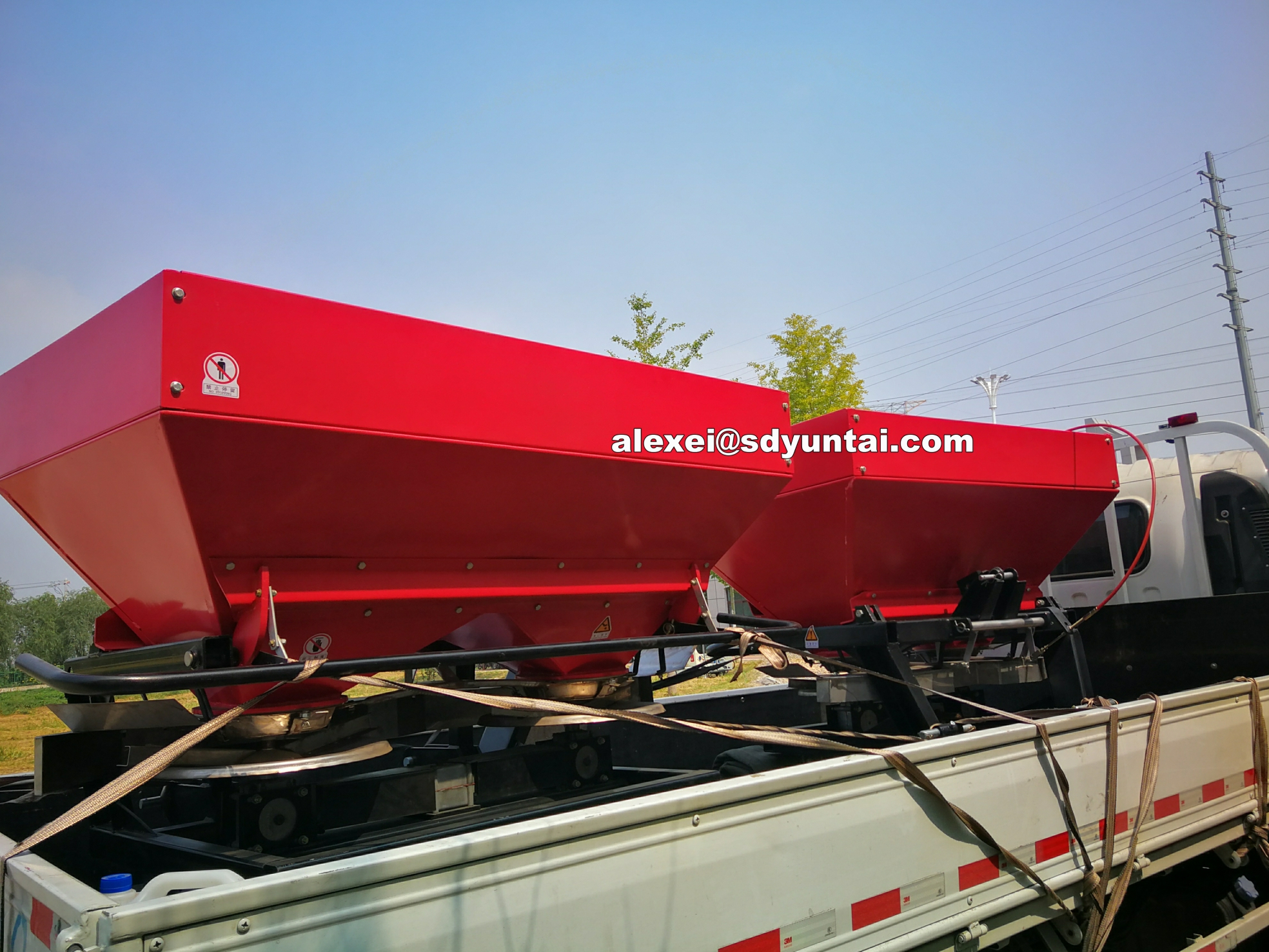 Rear view of the double disc fertilizer spreader showing adjustable components