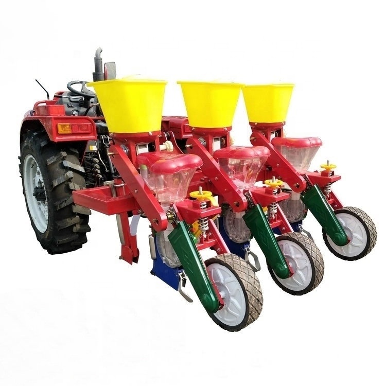 Tractor-mounted 4-row precision corn seeder with individual seed hoppers and 3-point linkage.
