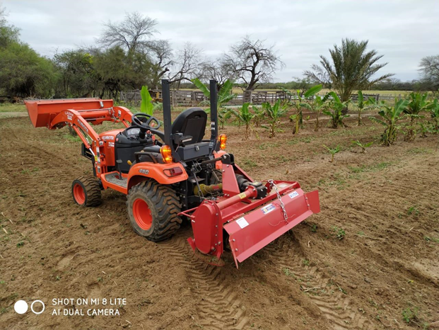 Compact tractor with rear-mounted PTO rotary tiller