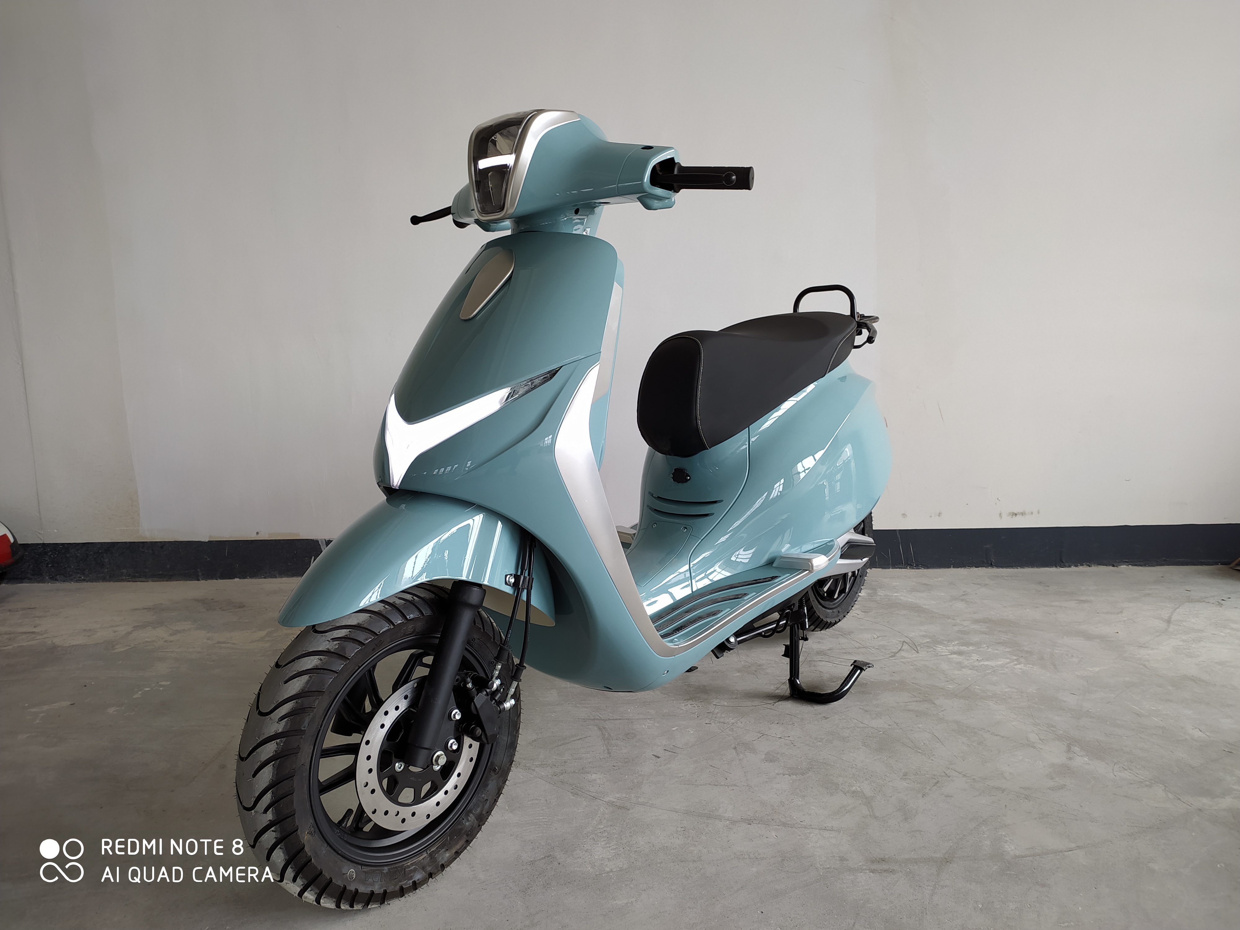 Front view of electric motorcycle showing LED lighting
