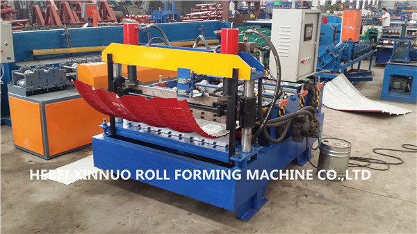 Full view of the sheet metal curving machine with blue base and red components