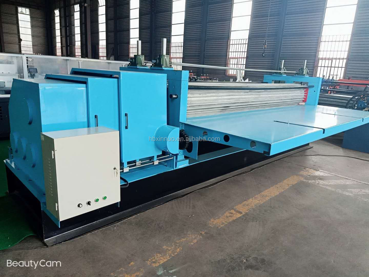 Close-up of sheet forming rollers and adjustment system