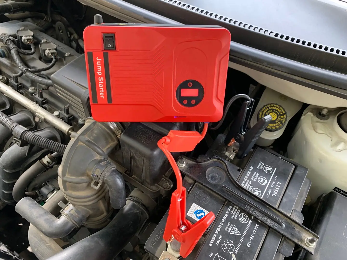Jump starter connected to car battery