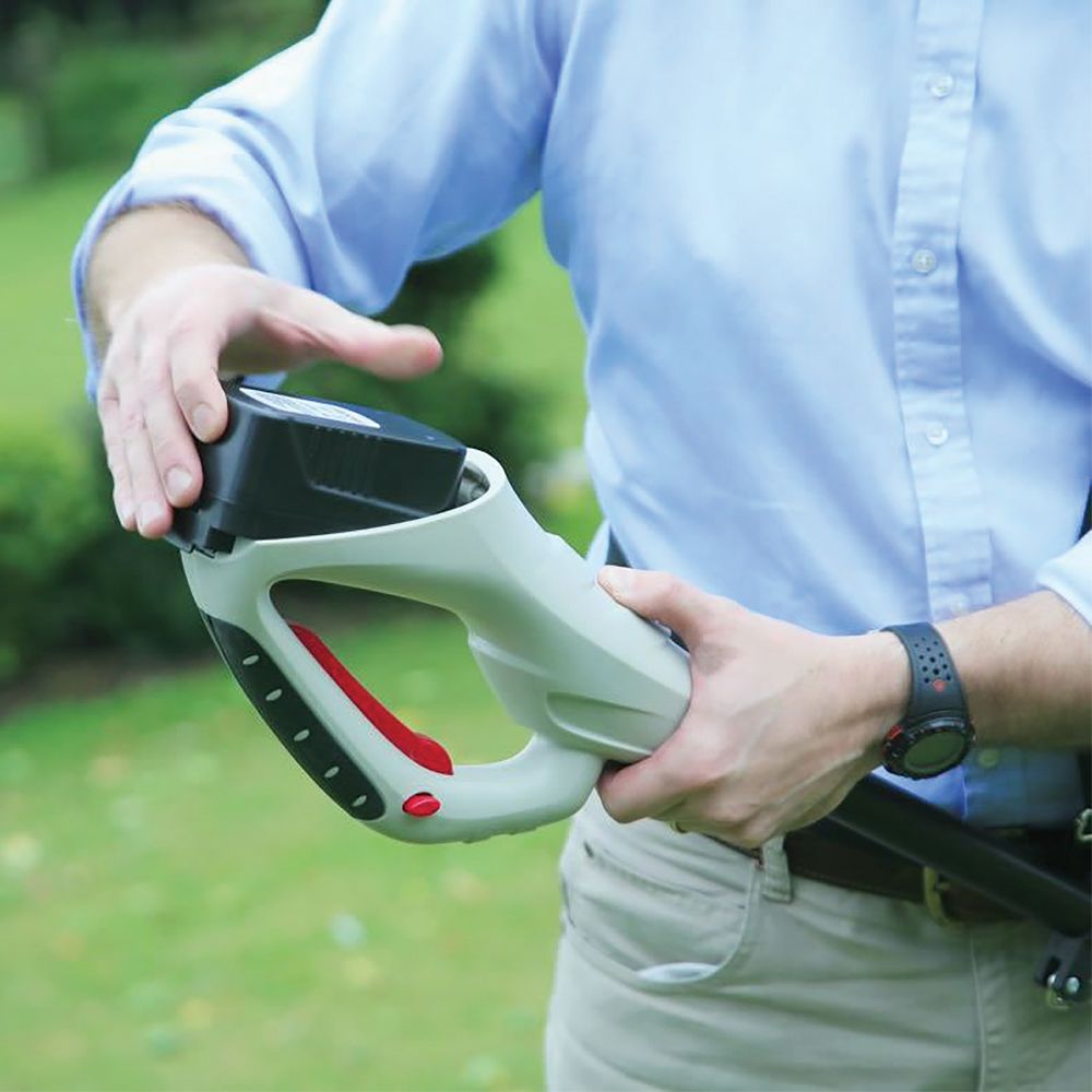 Cordless garden tiller in use