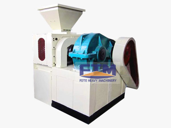 Industrial charcoal briquette machine showing feeding hopper and heavy-duty gearbox