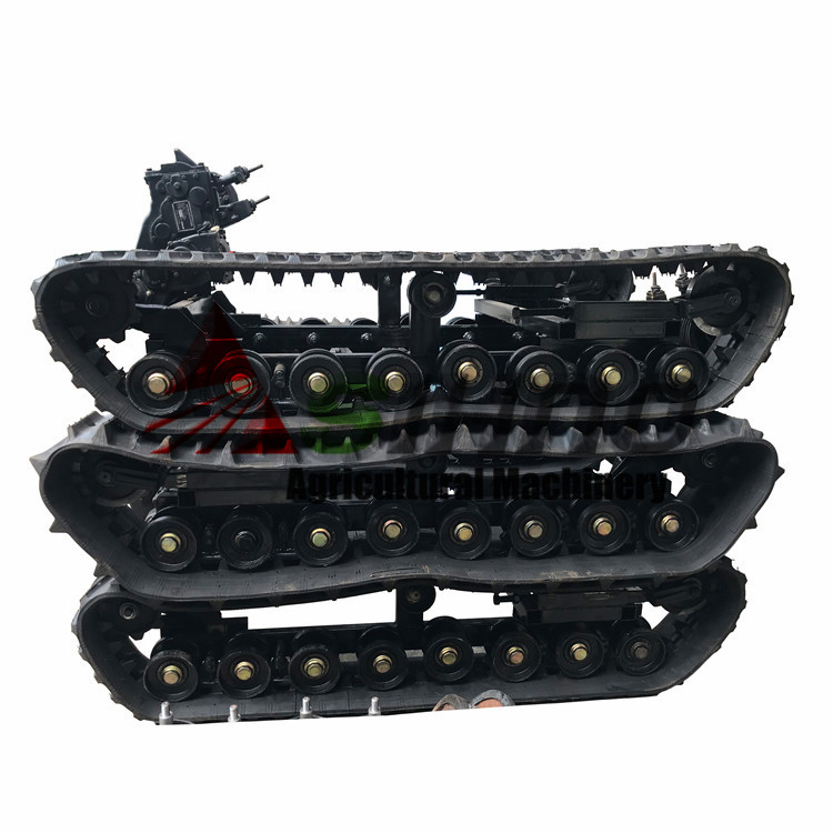 Side view of the rubber track undercarriage system showing the steel frame and rollers.