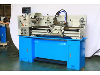 CNC lathe featuring a robust blue cabinet base and flexible coolant nozzle