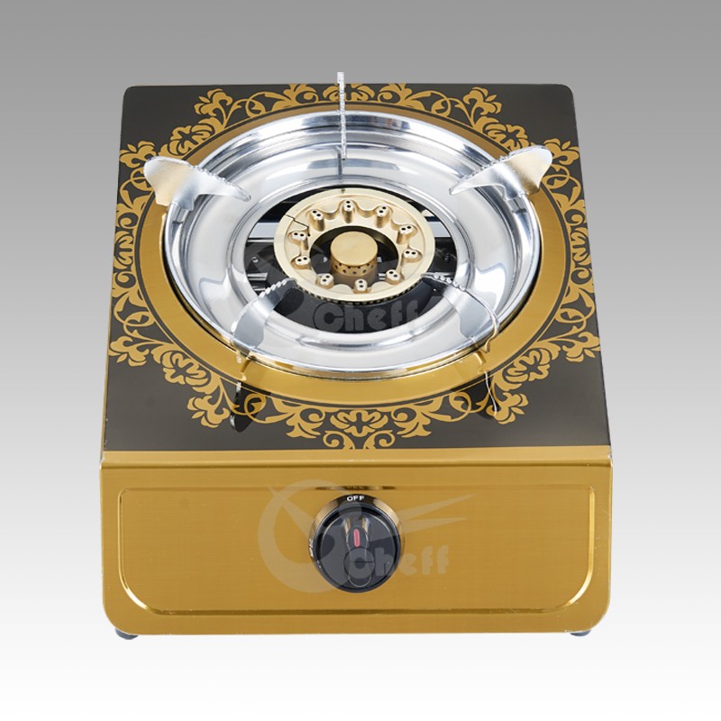 Single burner gas stove with gold finish and decorative pattern