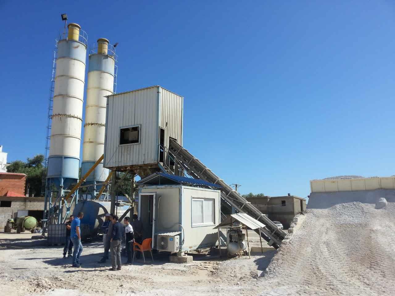 Full view of a concrete batching plant with silos and conveyors