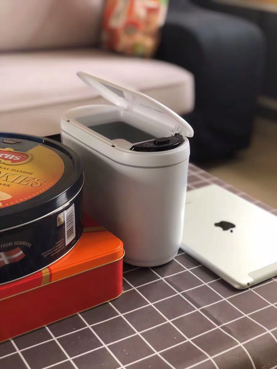 Compact desktop trash can in a home office setting