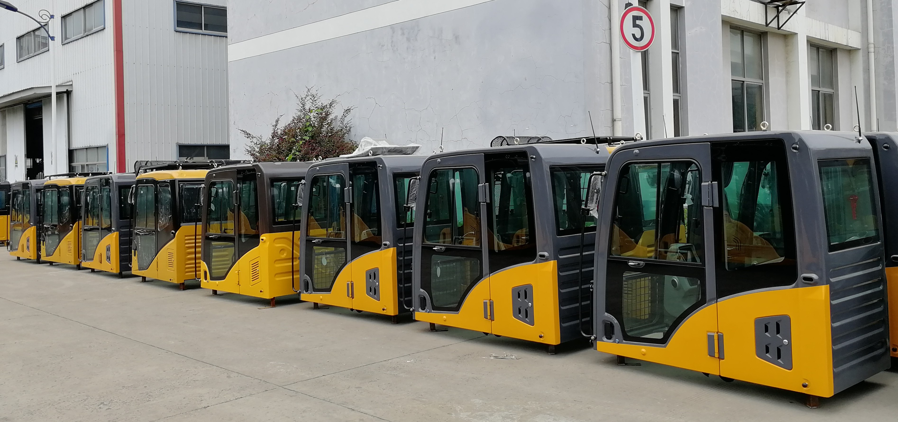Yellow and gray operator cabins for heavy equipment