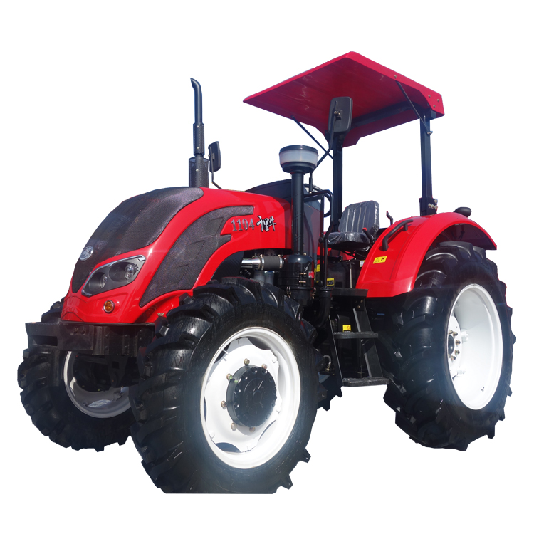 A robust wheel tractor in a field setting, showing heavy-duty tires and operator cabin.