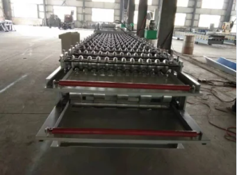 Close-up of the roll forming machine's structural frame and roller assembly.
