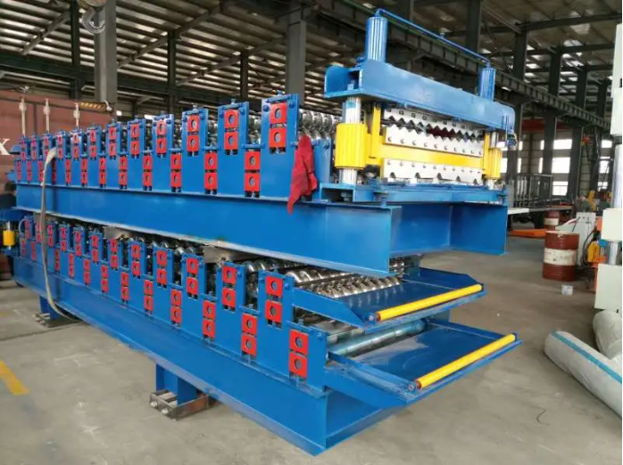 Full view of the blue industrial roll forming machine in a factory setting.