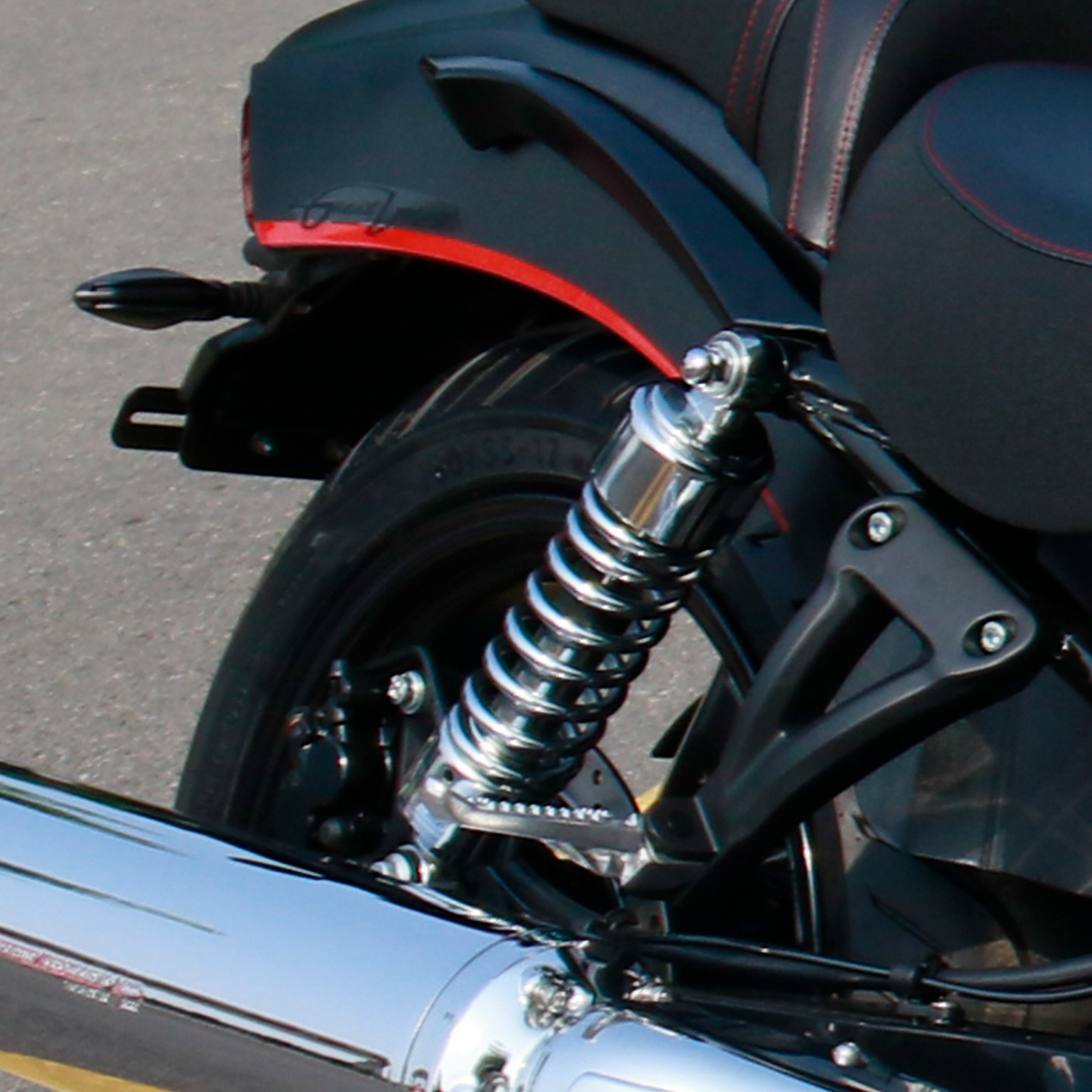 Detailed view of the rear suspension shock absorber and chrome exhaust.