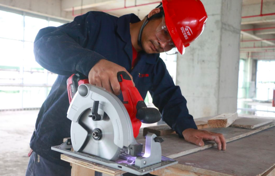 Close-up of the 20V cordless circular saw showing the battery interface and motor housing.