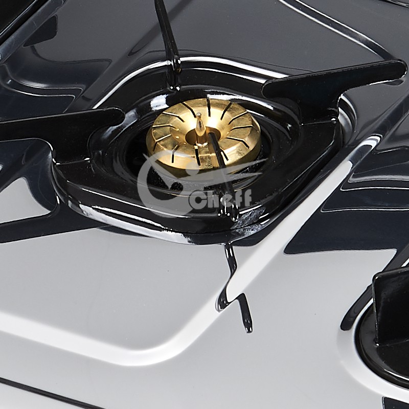 Close up of the brass burner caps and pan supports