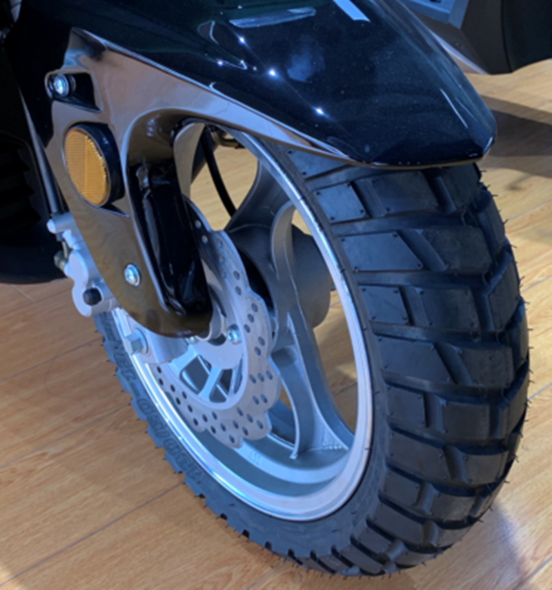 Close up of front wheel, tire, and disc brake