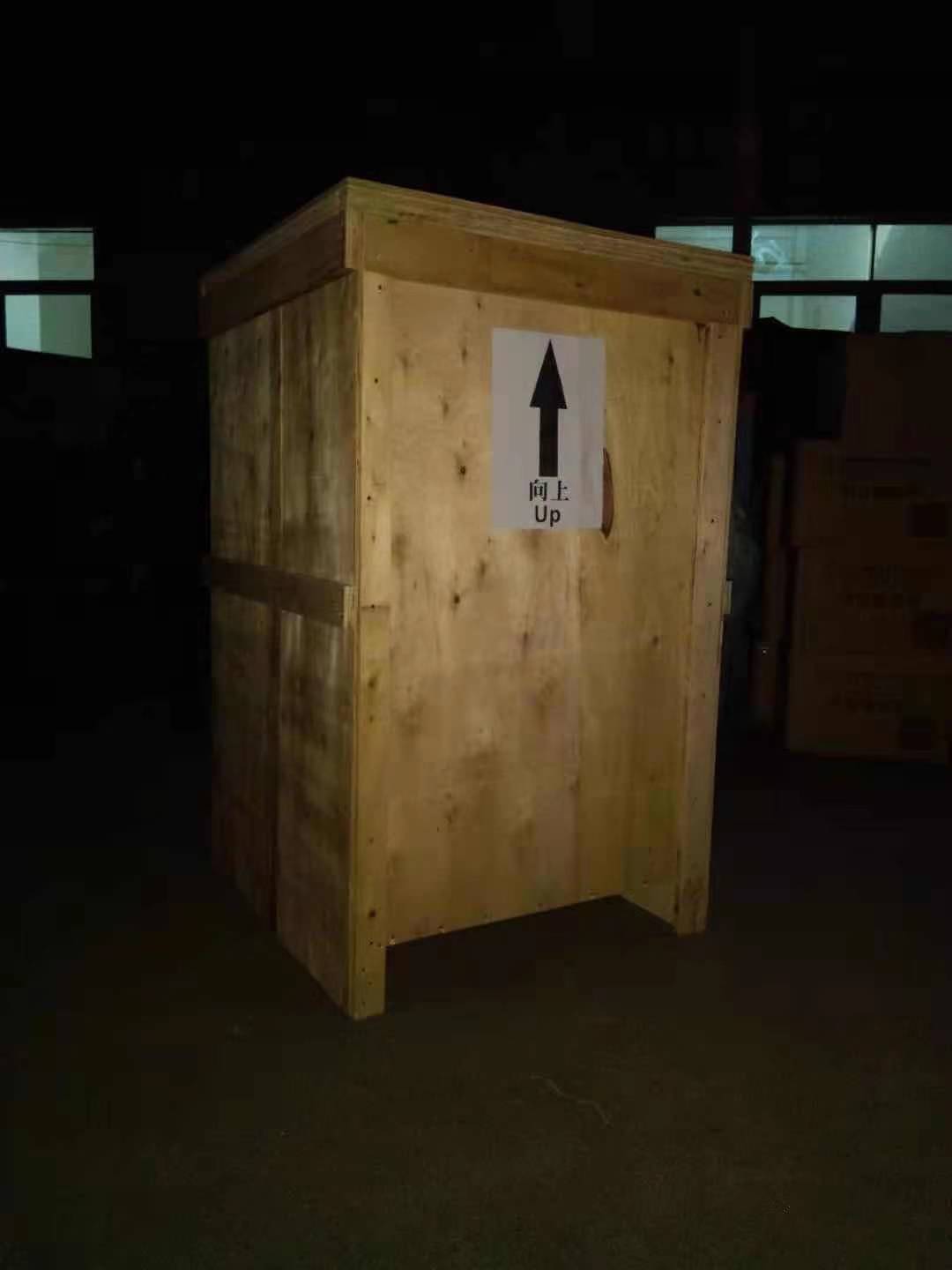 Industrial washing machine in wooden shipping crate