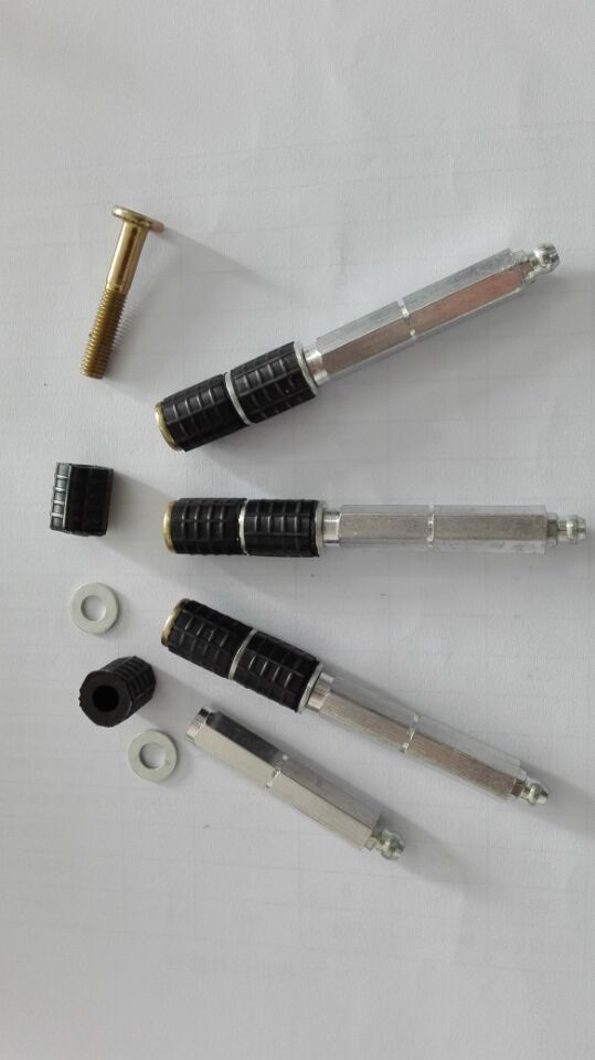 Close-up of 3/8 inch concrete injection packer components including metallic body, threaded bolt, and rubber sleeve.
