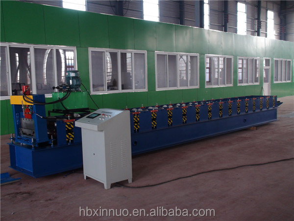 Roll forming machine showing blue steel frame and forming stations