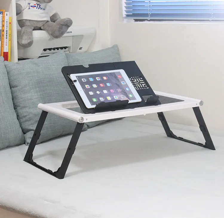 Portable laptop table setup on a bed