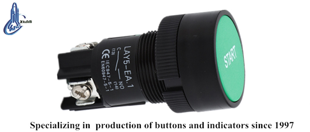 Close up of the green push button switch showing terminal markings