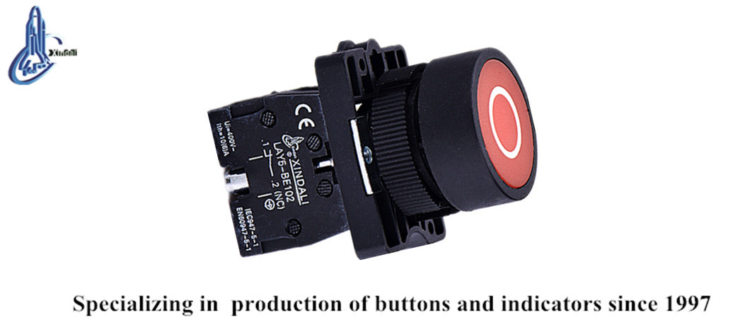 Close up of the electrical button switch showing contact block and terminal labels