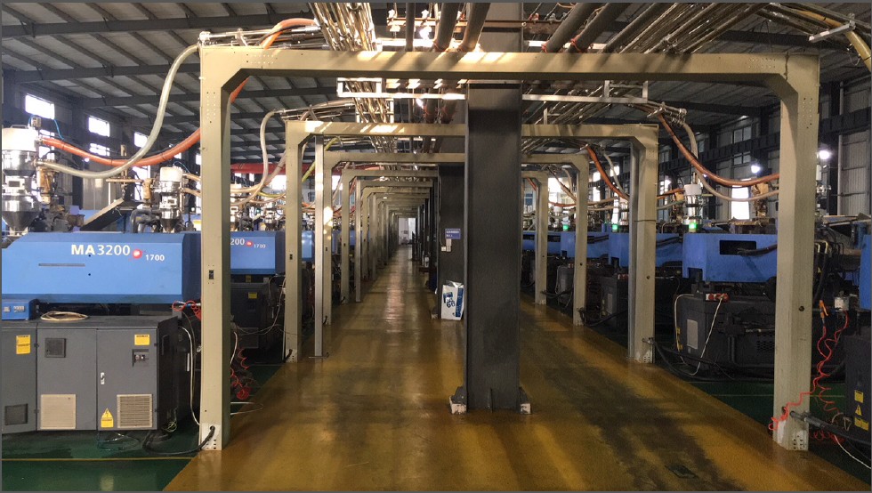 Manufacturing facility floor showing injection molding machines for cable ties