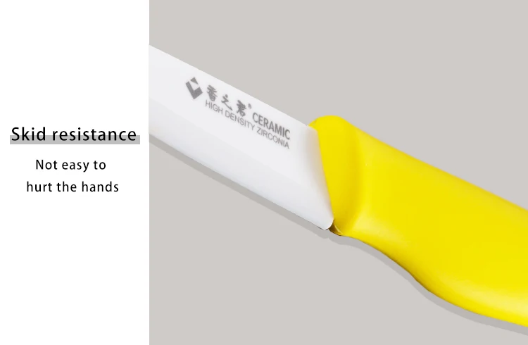 Ceramic knife with yellow handle showing grip texture.