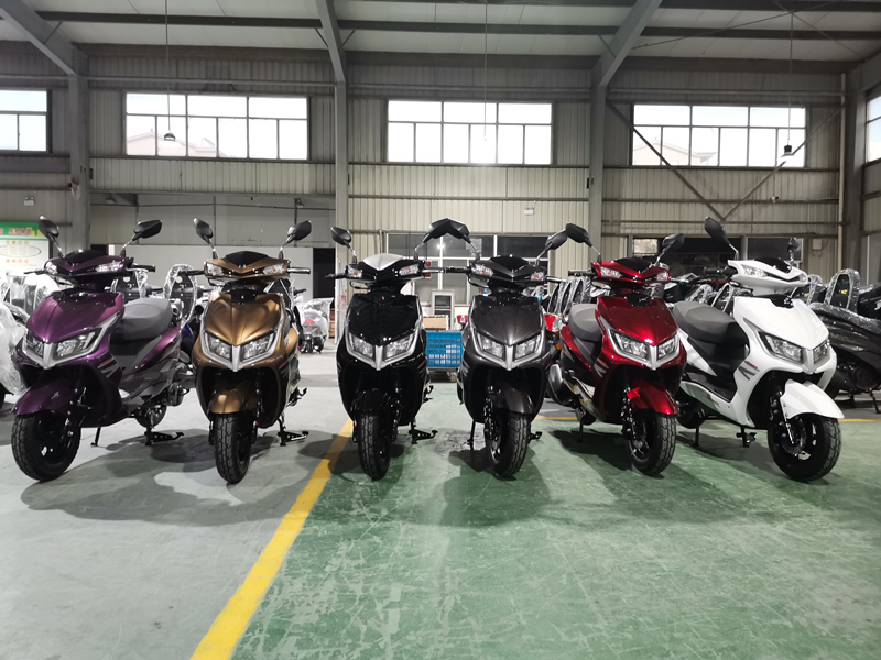 A collection of 150cc scooters in various colors displayed indoors.