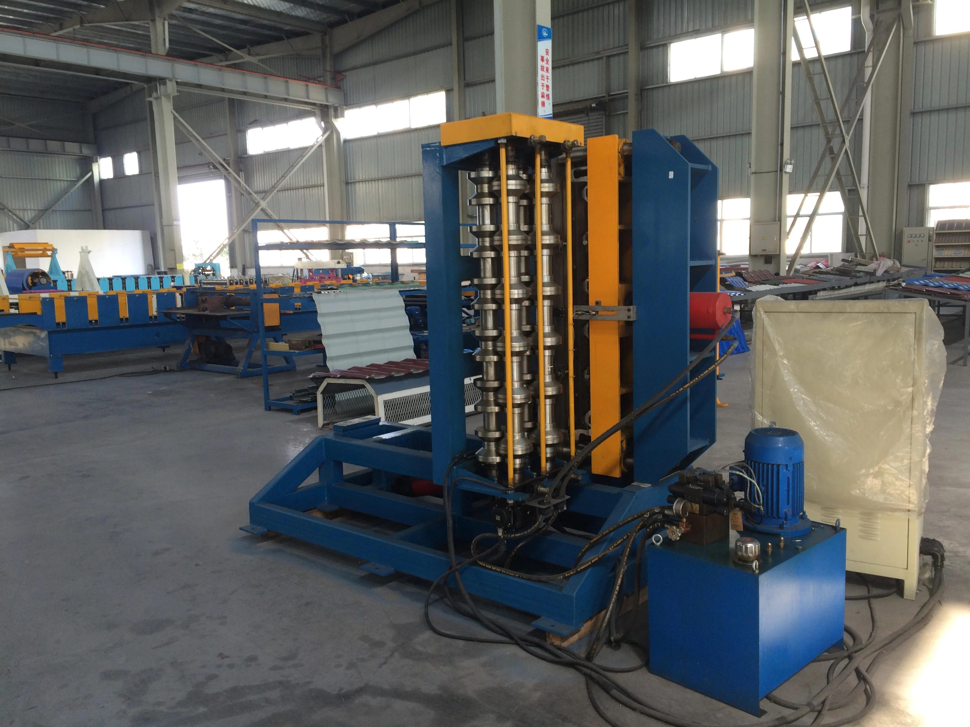 Industrial roll forming machine showing hydraulic system and frame
