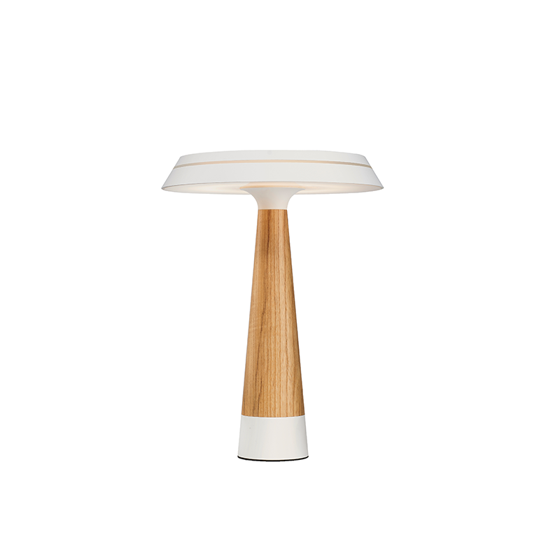 Modern white table lamp with wooden base on a bedside table