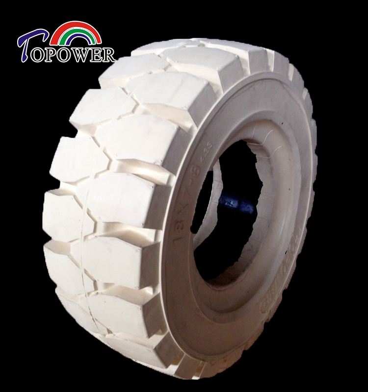 Close up of 18x7-8 non-marking solid tire showing tread pattern and sidewall markings