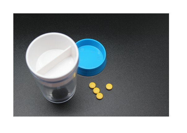 Clear plastic pill case with blue lid