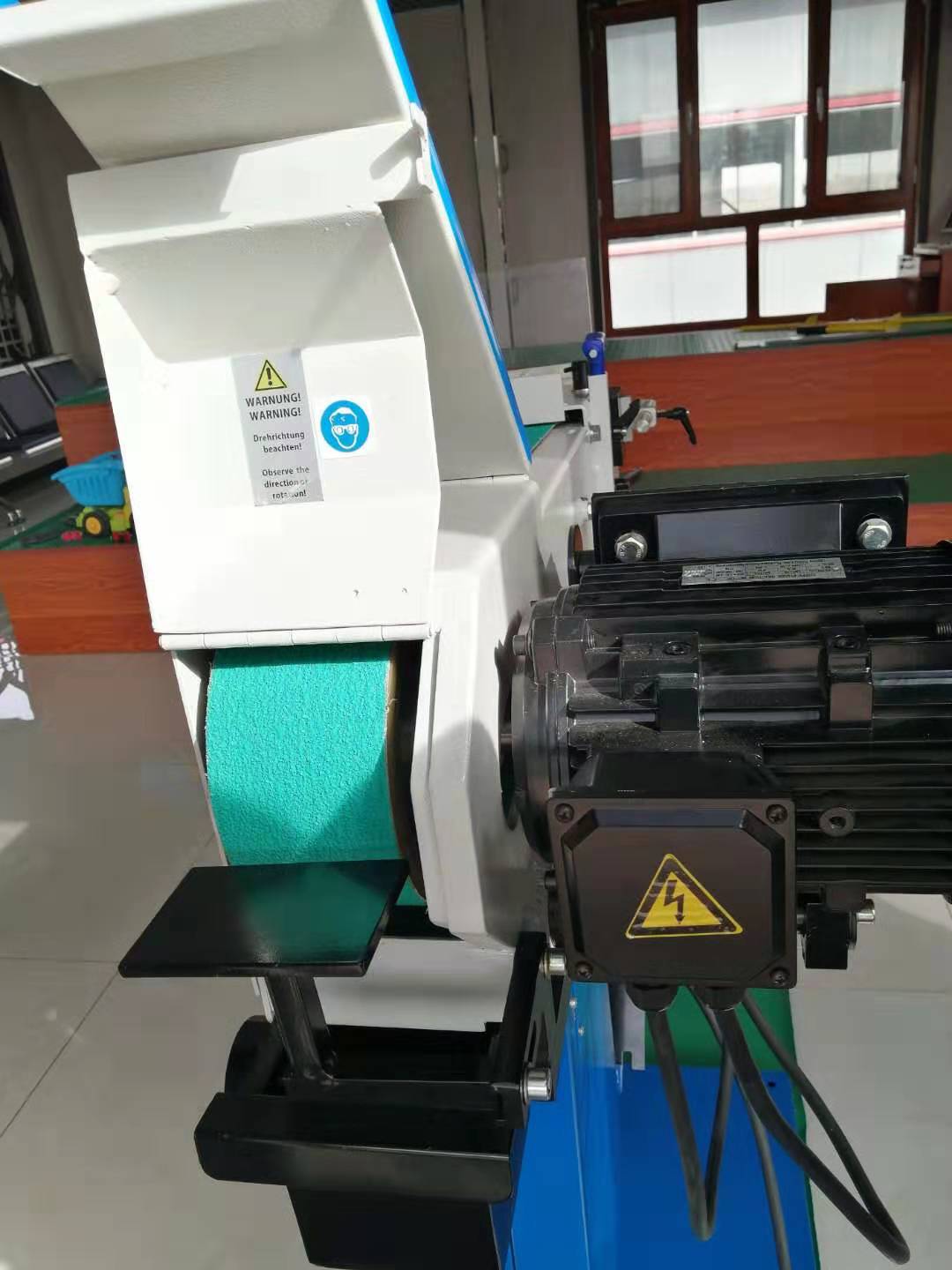 Industrial pipe notcher machine with visible safety warning labels