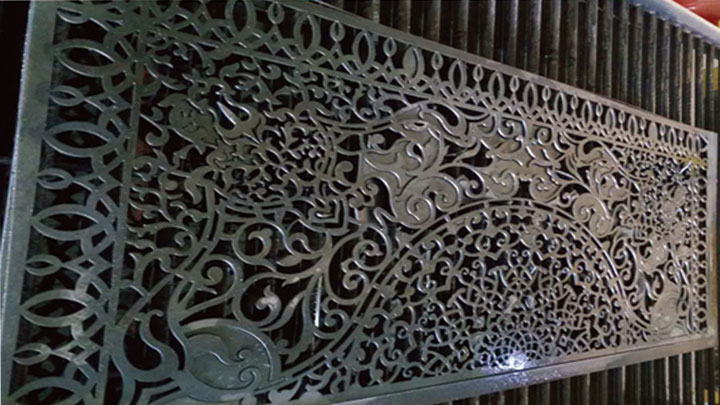 Intricate metal panel with floral cut-out design