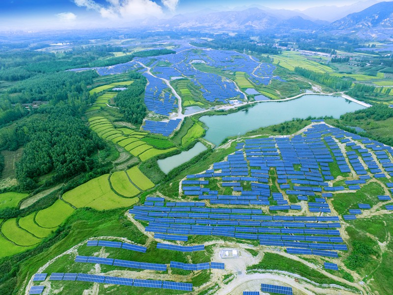 Aerial view of a vast solar farm in a rural setting