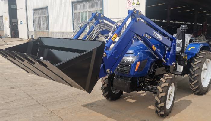 The QLN304 tractor with front-end loader in an agricultural field