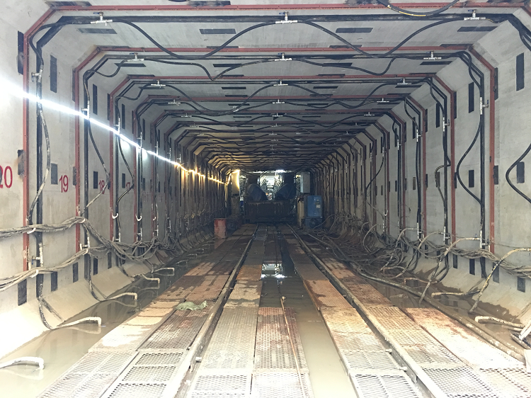 The tunneling machine in operation within a concrete passage