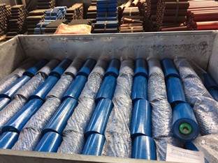 Conveyor system return roller in a workshop setting