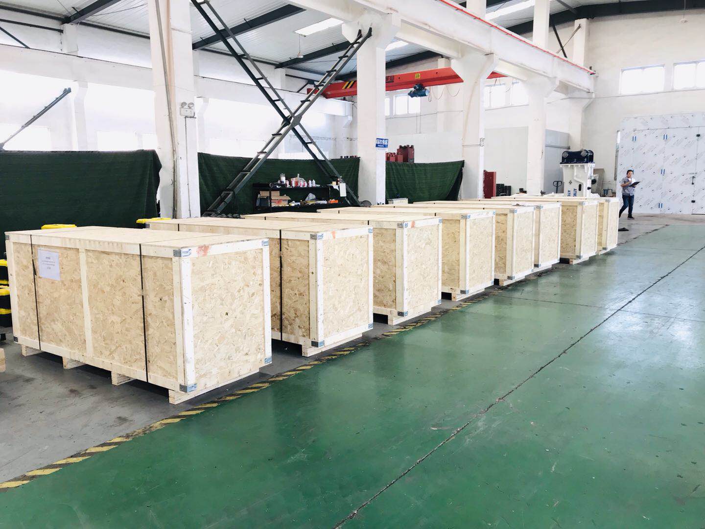 Hydraulic breakers packed in wooden crates for export.