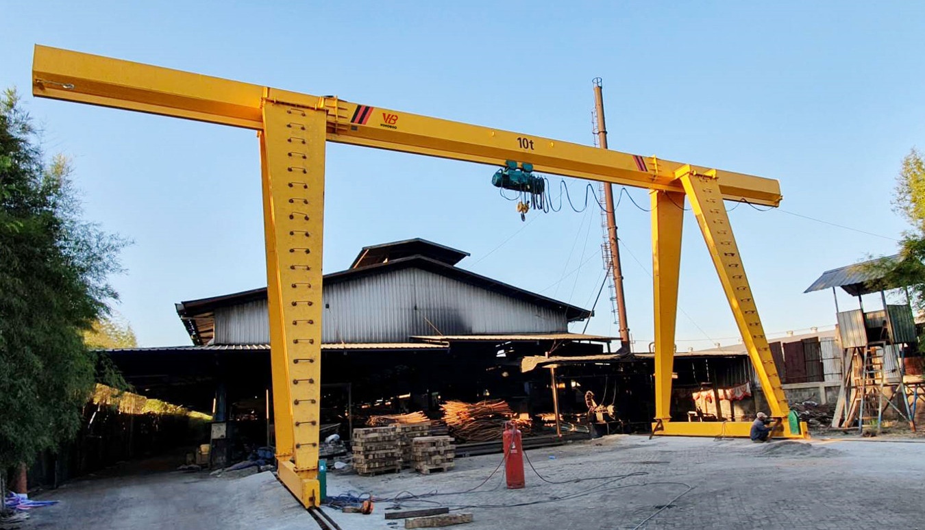 Single girder gantry crane in bright yellow for industrial use