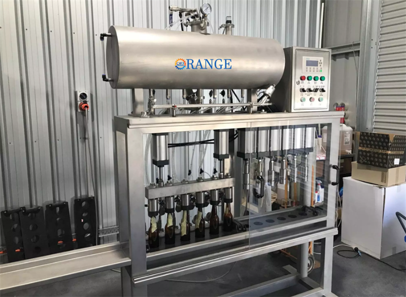 Close-up of bottle filling and capping assembly