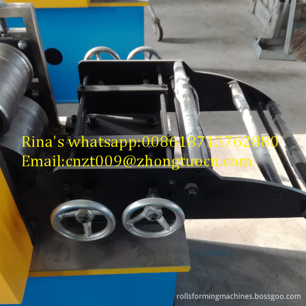 Close up of perforated shutter door machine rollers