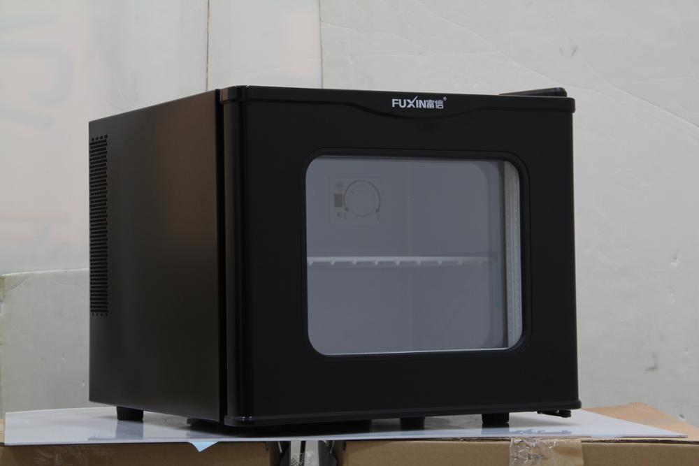 Mini bar fridge with interior illumination and transparent door view